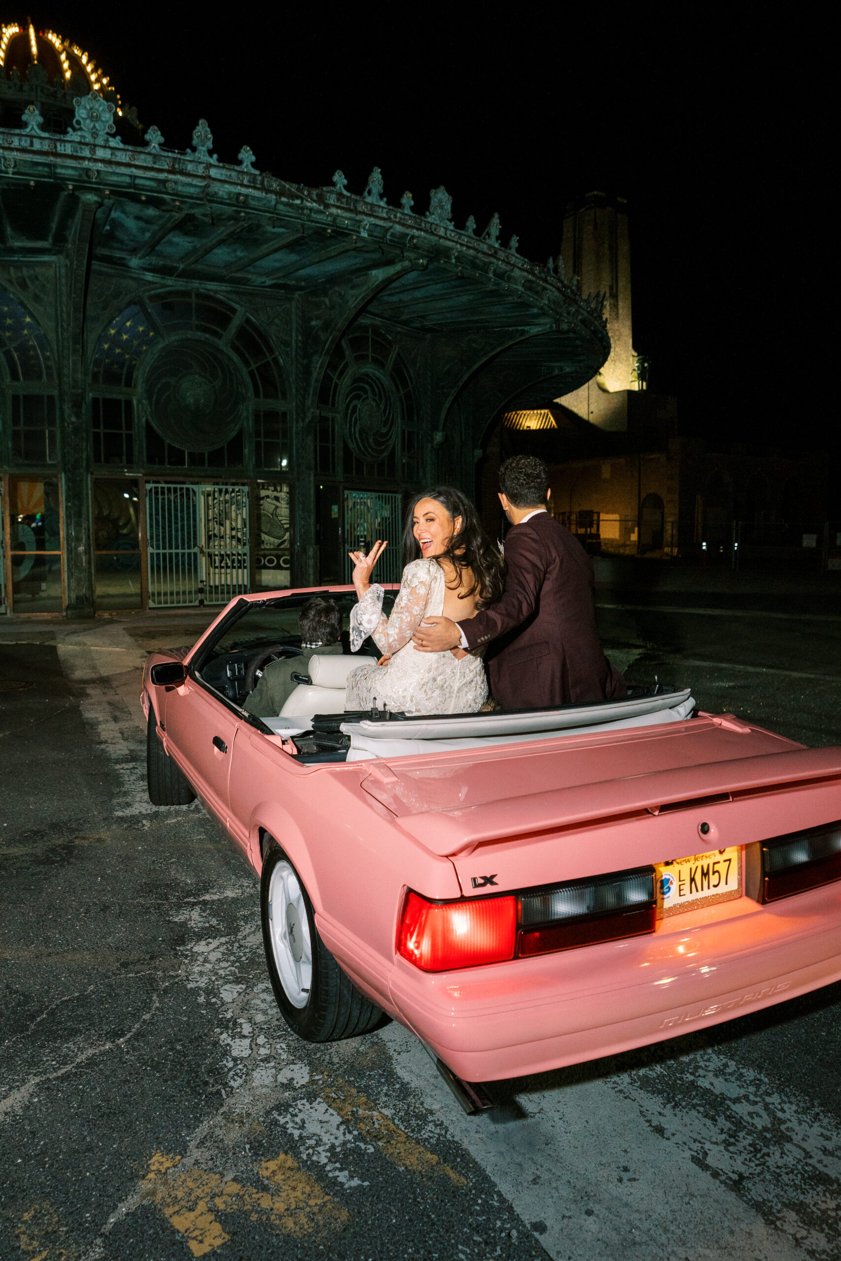 car with bridal couple