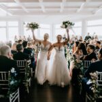A Waterfront Wedding Featuring The Couple’s Dog & Pride Flags at the Ceremony