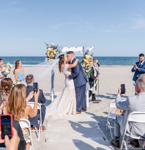 The wedding of Colorful Florals And a Beautiful Beach Ceremony at This Shore Wedding